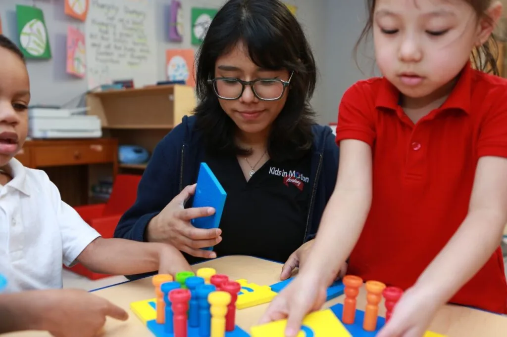 KIMA teacher supporting young learners